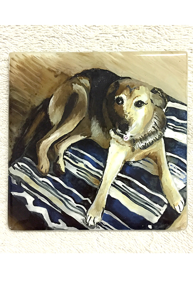 Coaster with a painted dog on it