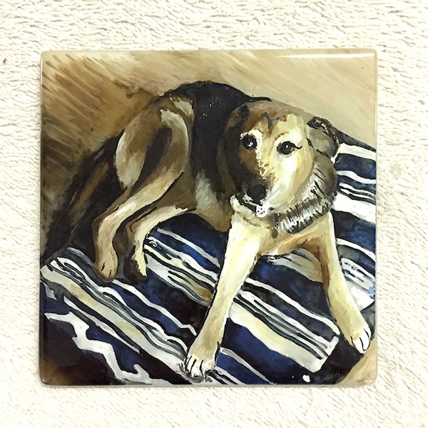 Coaster with a painted dog on it